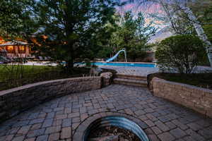 Patio terrace at dusk featuring a gazebo