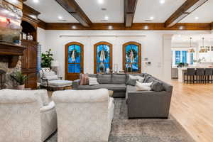 Living room with beam ceiling and light hardwood / wood-style flooring