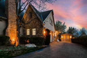 Property exterior at dusk with a storage unit