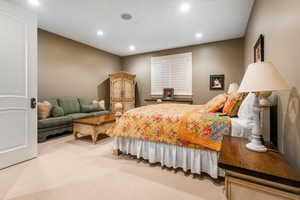 Bedroom featuring light colored carpet