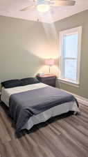 Bedroom featuring ceiling fan and hardwood / wood-style flooring