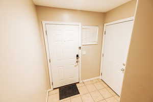 Entryway featuring light tile patterned floors