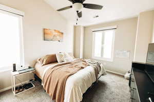 Bedroom with ceiling fan and carpet