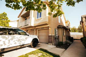 View of home's exterior featuring a balcony and a garage