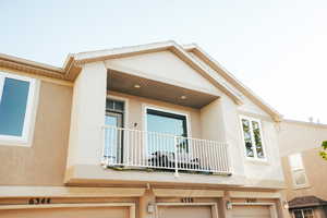 Exterior space featuring a garage and a balcony