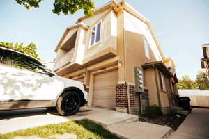 View of property exterior featuring a garage