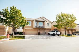 View of front of property with a balcony and a garage