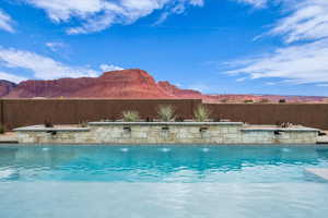 View of swimming pool with a mountain view and pool water feature