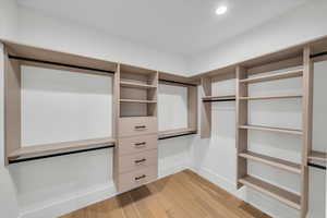 Spacious closet featuring light hardwood / wood-style floors