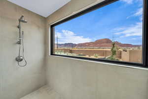 Interior space featuring tiled shower and a water and mountain view