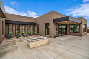 Back of property with a fire pit and a patio area