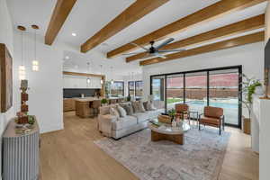 Living room with ceiling fan, beam ceiling, and light hardwood / wood-style flooring