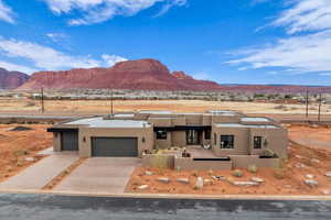 View of front facade featuring a garage and a mountain view