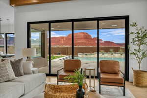 Living room with a mountain view, light hardwood / wood-style flooring, and a healthy amount of sunlight