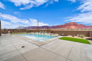 View of swimming pool with an in ground hot tub, a mountain view, and a patio