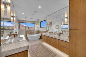 Bathroom featuring vanity and a tub