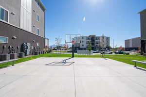 View of sport court featuring a lawn