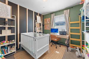 Carpeted bedroom with a crib