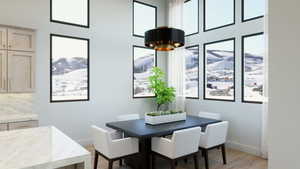 Dining area featuring an inviting chandelier and light wood-type flooring