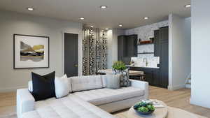 Living room featuring bar area and light hardwood / wood-style flooring