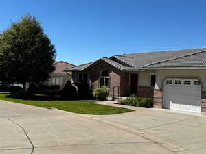 Ranch-style house with a garage and a front yard