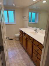 Bathroom featuring vanity, tile patterned flooring, and toilet