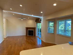 Family Room with gas fireplace, hardwood floors, sliding doors to covered deck