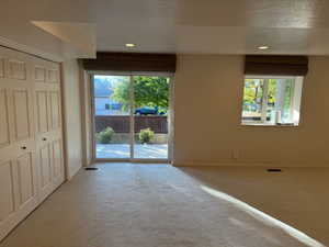 Downstairs family room with sliding glass doors to walkout back yard and covered patio - brand new carpet and pad