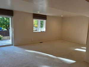 Downstairs family room with sliding glass doors to walkout back yard and covered patio - brand new carpet and pad