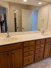 Master Bathroom featuring two sinks and linen closet