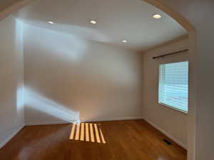 Living room with hardwood floors just off foyer entrance