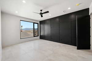 Spare room featuring ceiling fan, a mountain view, and a textured ceiling