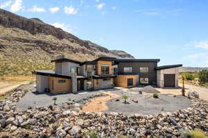 Front of house with a mountain view. Landscape has changed