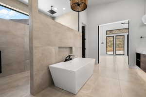 Bathroom featuring ceiling fan, separate shower and tub, tile patterned floors, and a wealth of natural light