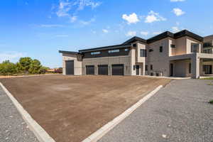 View of front of house featuring central air condition unit and a garage