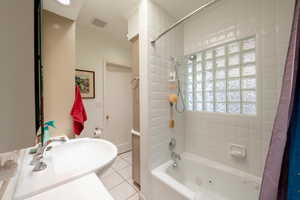 Bathroom with shower / bath combo with shower curtain, crown molding, tile patterned floors, and vanity