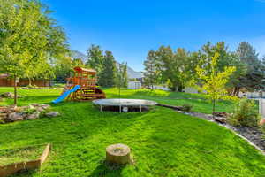 View of yard with a playground and a mountain view