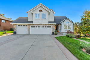 Front facade with a front yard and a garage