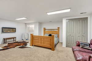 Bedroom with a closet and light carpet