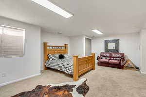 Bedroom featuring light carpet