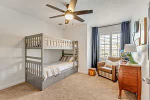 Bedroom featuring ceiling fan and carpet flooring