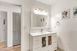 Bathroom featuring hardwood / wood-style flooring and vanity