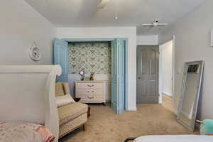 Carpeted bedroom with ceiling fan