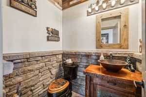 Bathroom featuring a wainscoted wall and vanity
