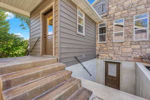 Doorway to property with stone siding