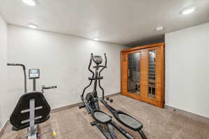 Exercise area featuring carpet floors and baseboards