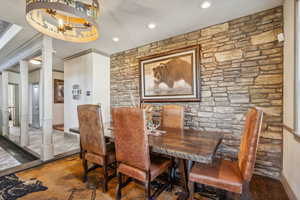 Dining room with recessed lighting, decorative columns, and an inviting chandelier