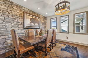 Dining area featuring a chandelier, recessed lighting, wood finished floors, and baseboards