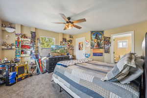 Bedroom featuring ceiling fan and carpet flooring