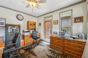 Office area featuring ornamental molding, ceiling fan, and baseboards